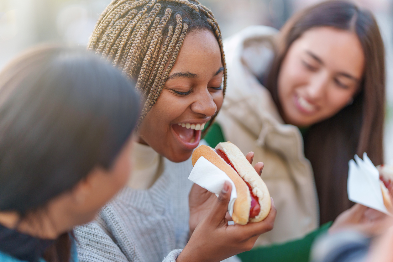 woman eating hotdog