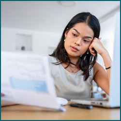 woman looking a bills